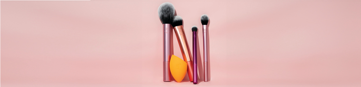 A range of makeup brushes and a sponge from Real Tecnniques